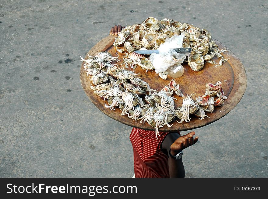 Woman selling crab meat on the street in africa. Woman selling crab meat on the street in africa