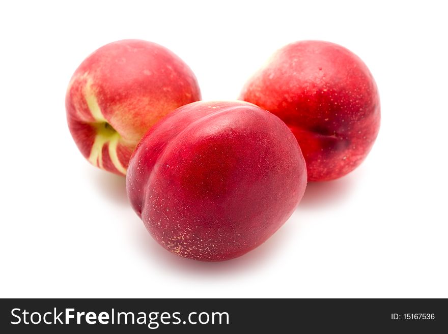 Garden-stuffs juicy ripe nectarine on a white background