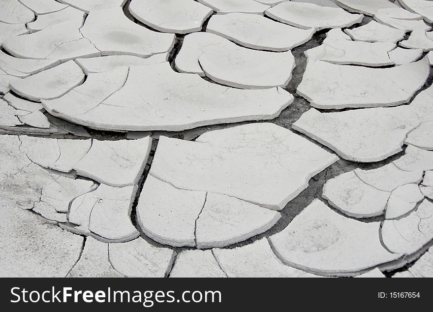 The cracked dried up grey soil, image. The cracked dried up grey soil, image