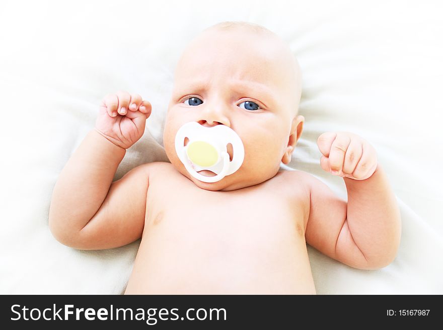 The baby sucks pacifier