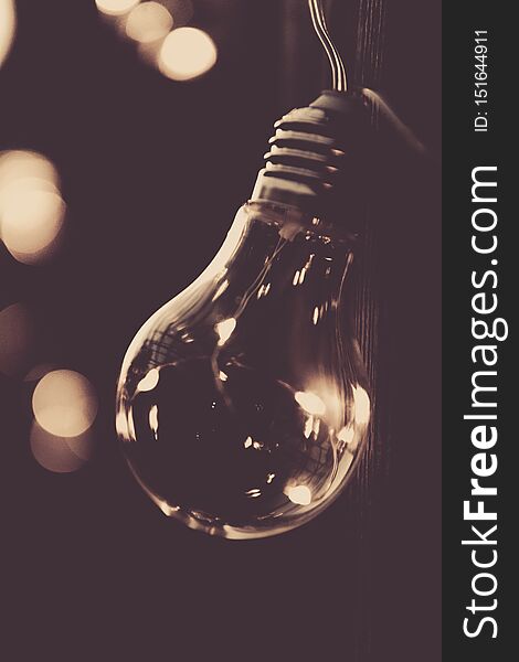 Image of glowing light bulb on dark background