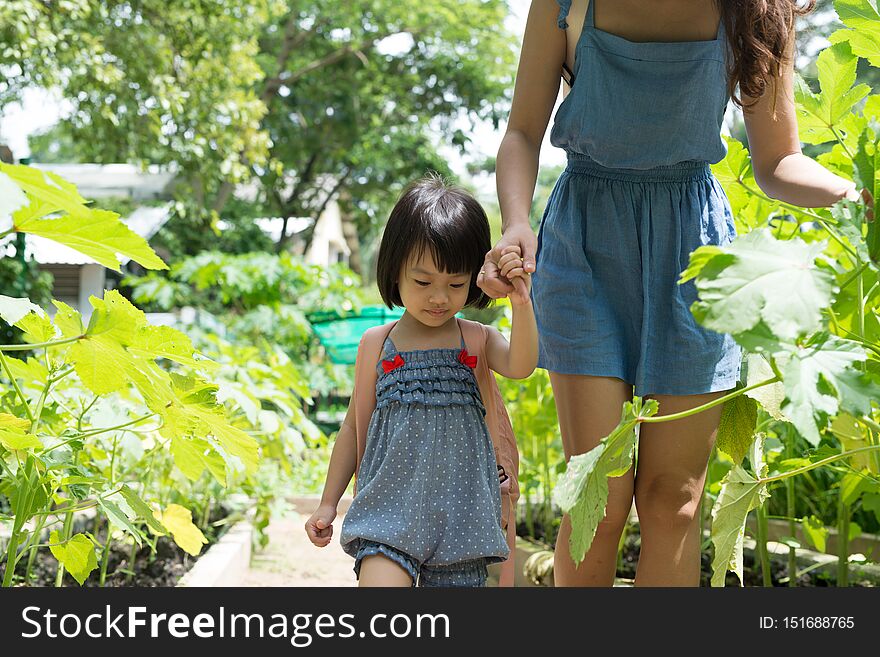 Happy Asian daughter gardening with her mother