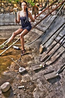 Attractive Woman In A Stone Hole Among Old Shovels Royalty Free Stock Images Attractive Woman In A Stone Hole Among Old Shovels Royalty Free Stock Images