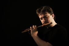 Man In Black Plays A Flute Royalty Free Stock Photography Man In Black Plays A Flute Royalty Free Stock Photography