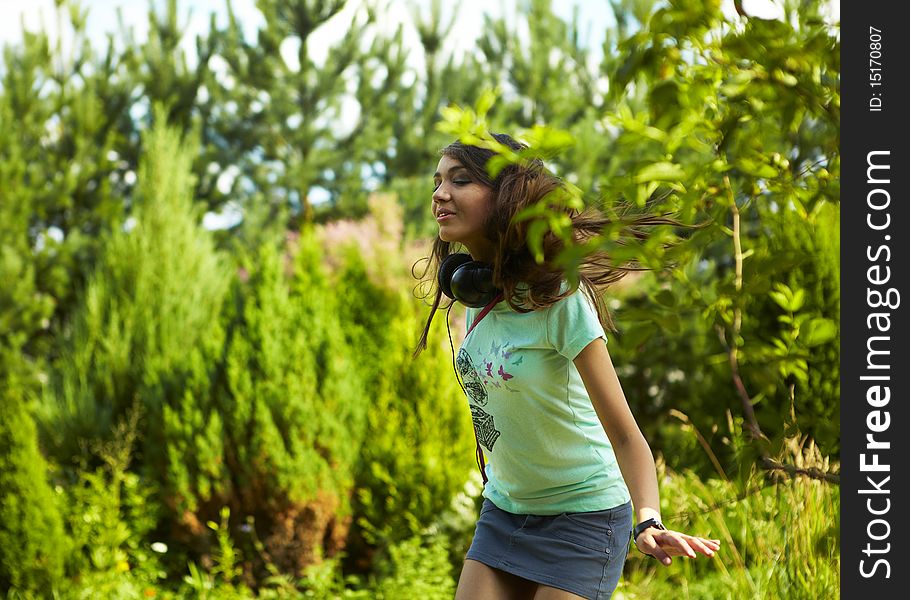 Young beautiful girl dancing outdoor. Photo.