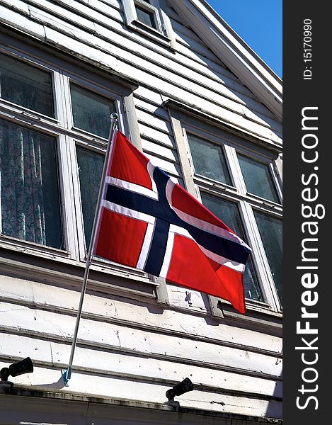 Norwegian Flag flies from an old timber house in Bryggen