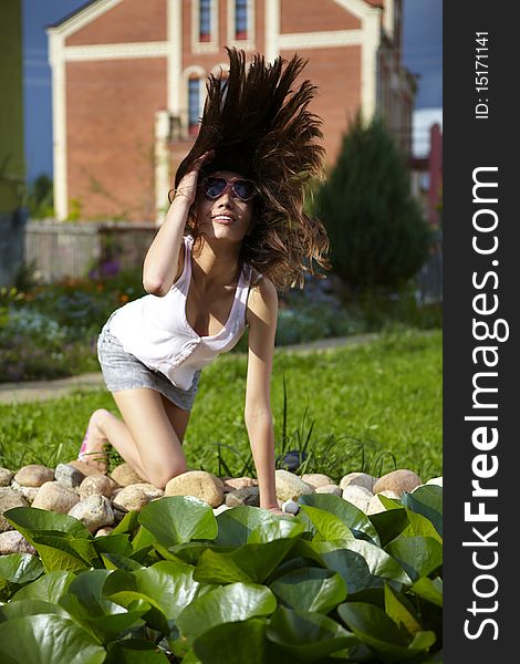 Young woman relaxing near pond.