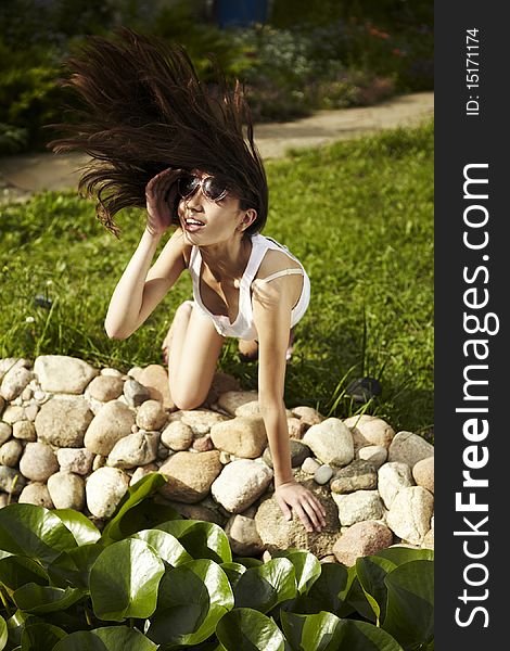 Young woman in Sun glasses have fun near pond. Young woman in Sun glasses have fun near pond.