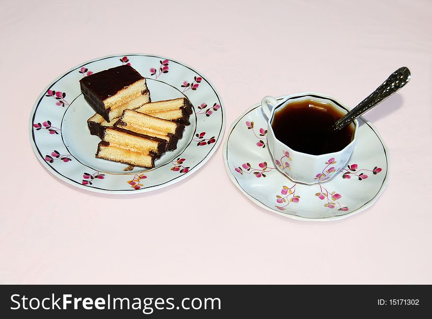 Coffee and cake on the background of a pink tablecloth