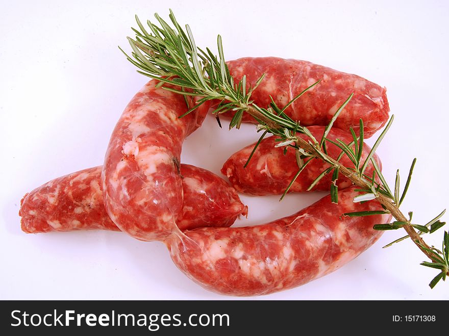 Pork sausages ready to be cooked on the grill with seasoning of rosemary. Pork sausages ready to be cooked on the grill with seasoning of rosemary