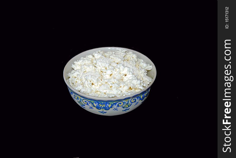 Curd in a bowl on a black background