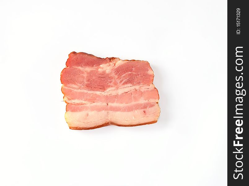 A slice of bacon with a light shade on white background. A slice of bacon with a light shade on white background