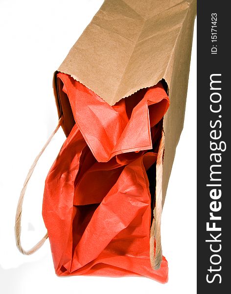 Gift with red tissue paper laying on its side. Gift with red tissue paper laying on its side.