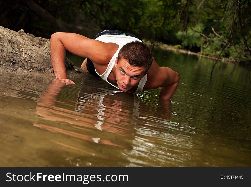 Man Doing Push-ups On The Beach