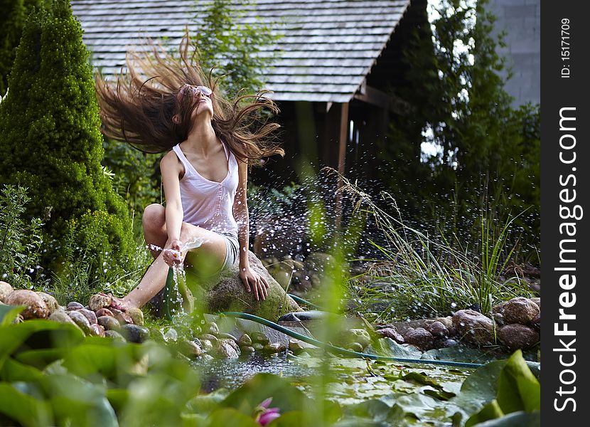 Young Happy Girl With Garden Streamlet Near Pond