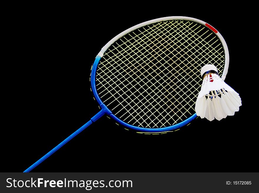 Racket and shuttlecock in black background