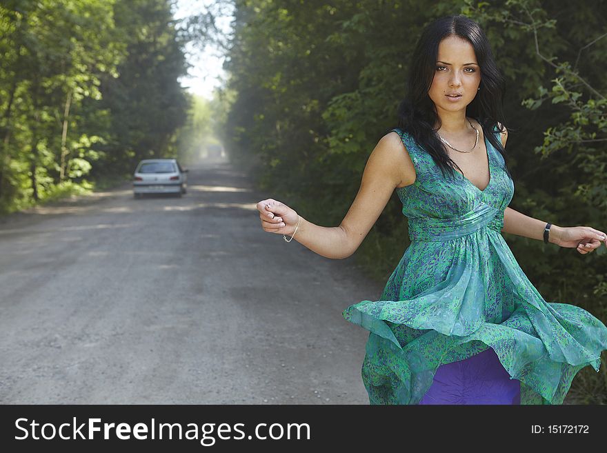 Girl in the road on summer dres.