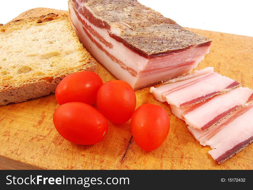 Foreground of bacon and tomato to prepare better a sandwich. Foreground of bacon and tomato to prepare better a sandwich