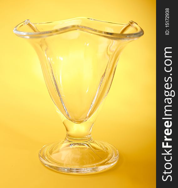 Empty wine glass isolated on yellow background