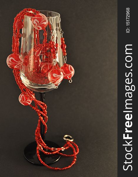 Red sparkling beads in a glass