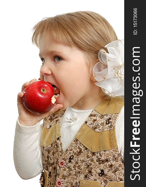 The little girl biting an apple on white