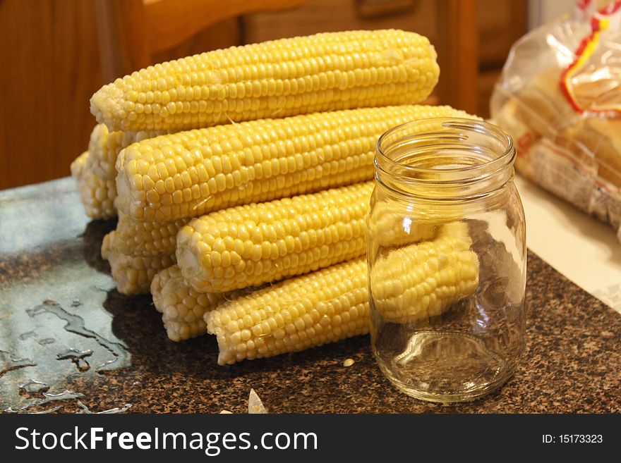 Ears of corn and canning jar