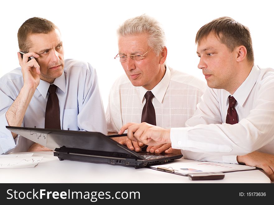 Three businessmen working on a white background. Three businessmen working on a white background