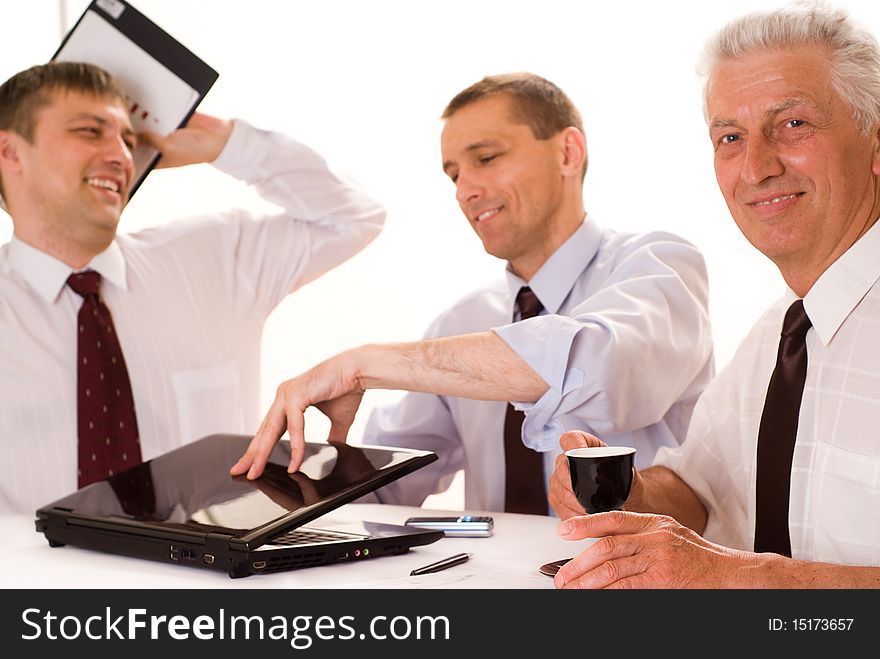 Three businessmen working on a white background