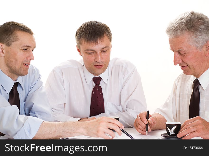 Three businessmen working on a white. Three businessmen working on a white