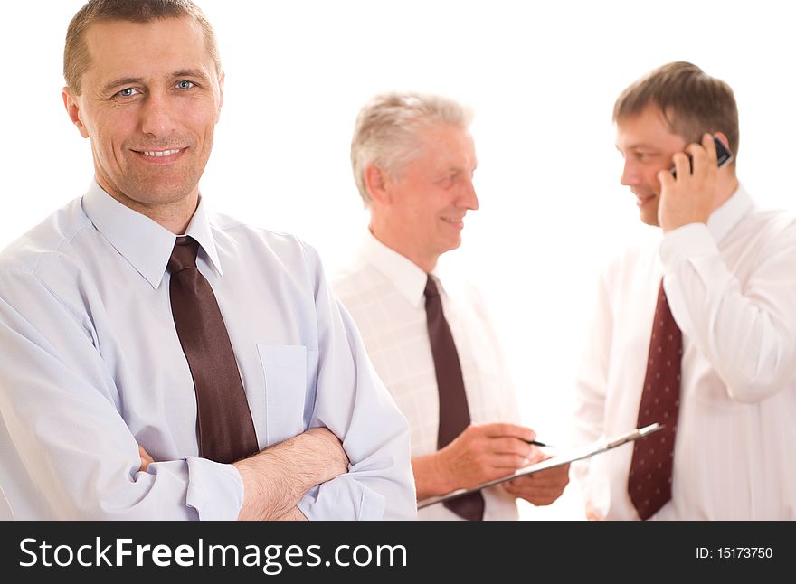 Three businessmen working on a white background. Three businessmen working on a white background