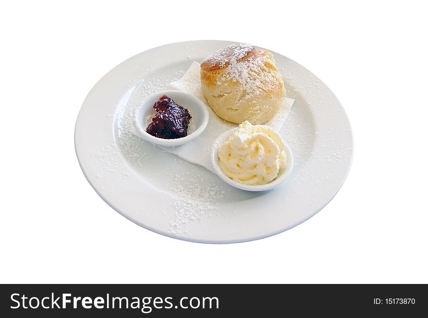 A traditional scone with whipped cream and strawberry jam isolated on white