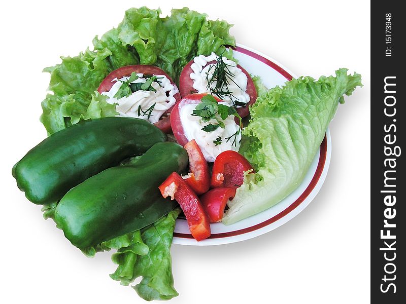 Plate with salad, tomatoes and pepper on a white background