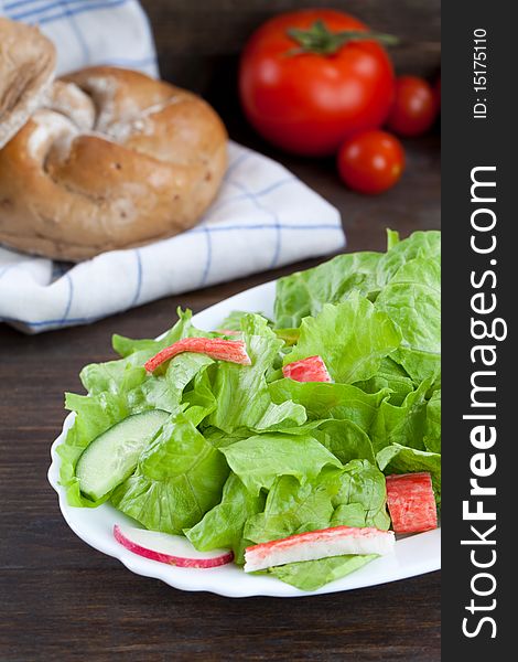 Lettuce salad with crab meat on wooden table top