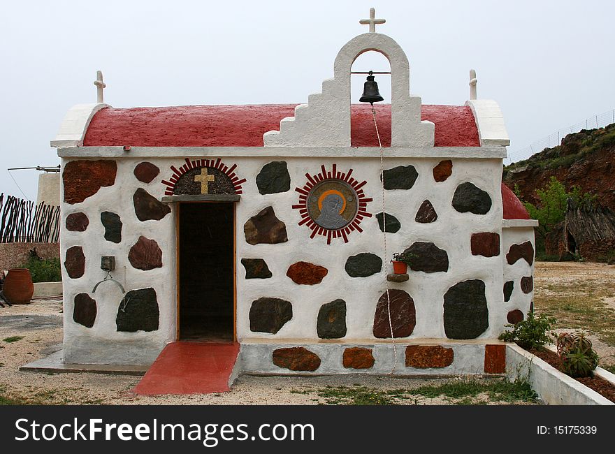 Small greek orthodox church in Crete island, attractive by its walls with colored stones. Small greek orthodox church in Crete island, attractive by its walls with colored stones