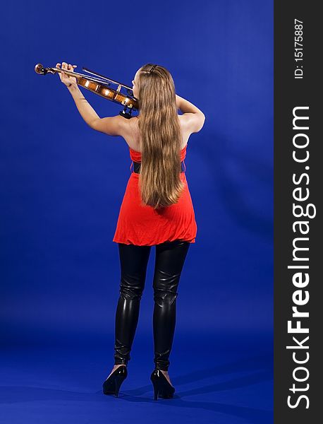 A young brunette woman playing violin. A young brunette woman playing violin