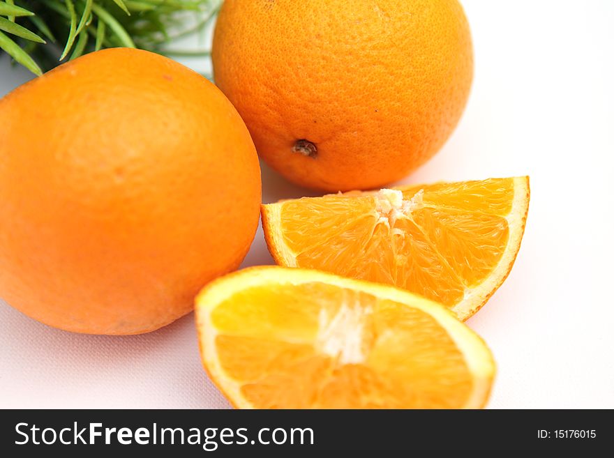 Fresh and juicy orange on table with green