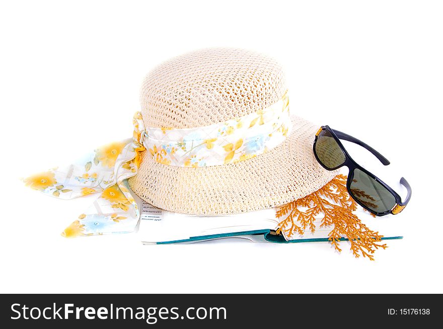 A set of lady's hat book and sunglasses isolated over white. A set of lady's hat book and sunglasses isolated over white