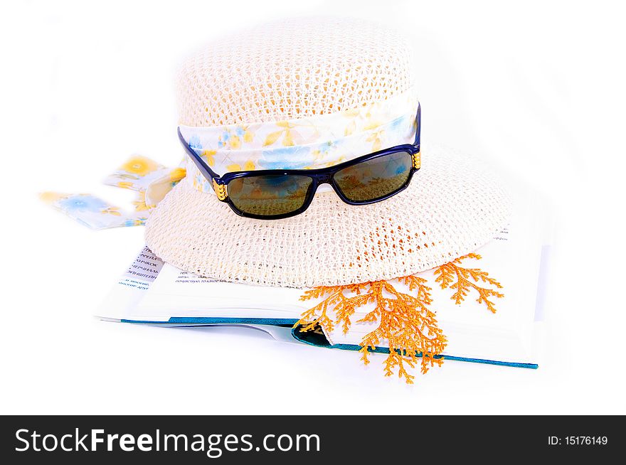 A set of lady's hat book and sunglasses isolated over white. A set of lady's hat book and sunglasses isolated over white