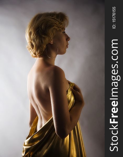 Beautiful Blonde Woman In Gold Fabric