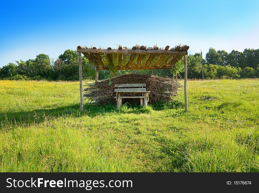 Garden furniture from wood and reeds in the meadow. Garden furniture from wood and reeds in the meadow