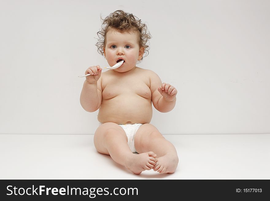 Sitting baby girl on white background