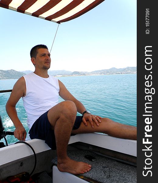 A man driving a boat in the Adriatic Sea