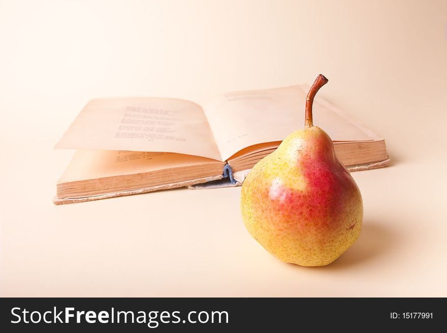 Fresh pear and old book