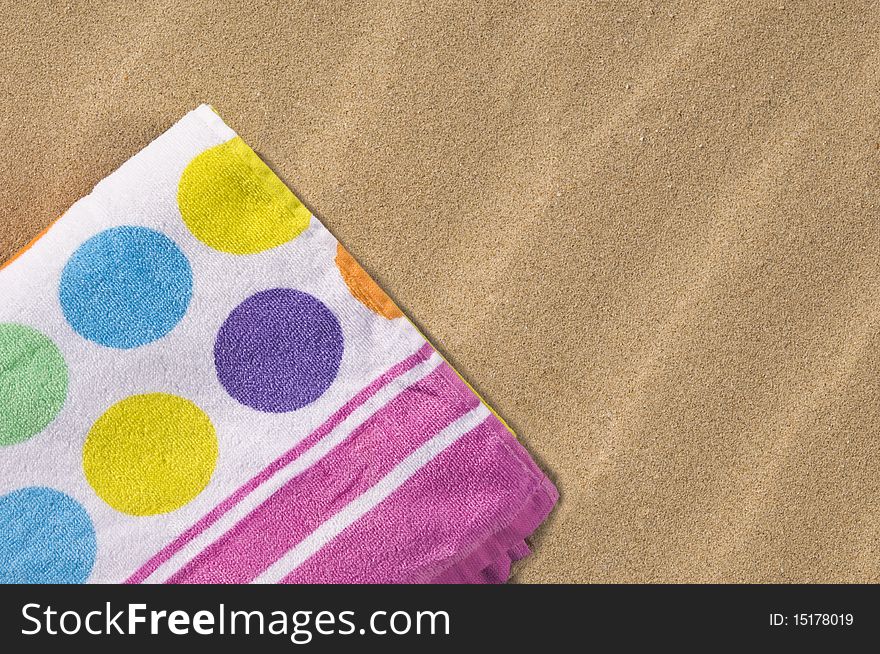 Spotted and folded towel on the sand. Spotted and folded towel on the sand.