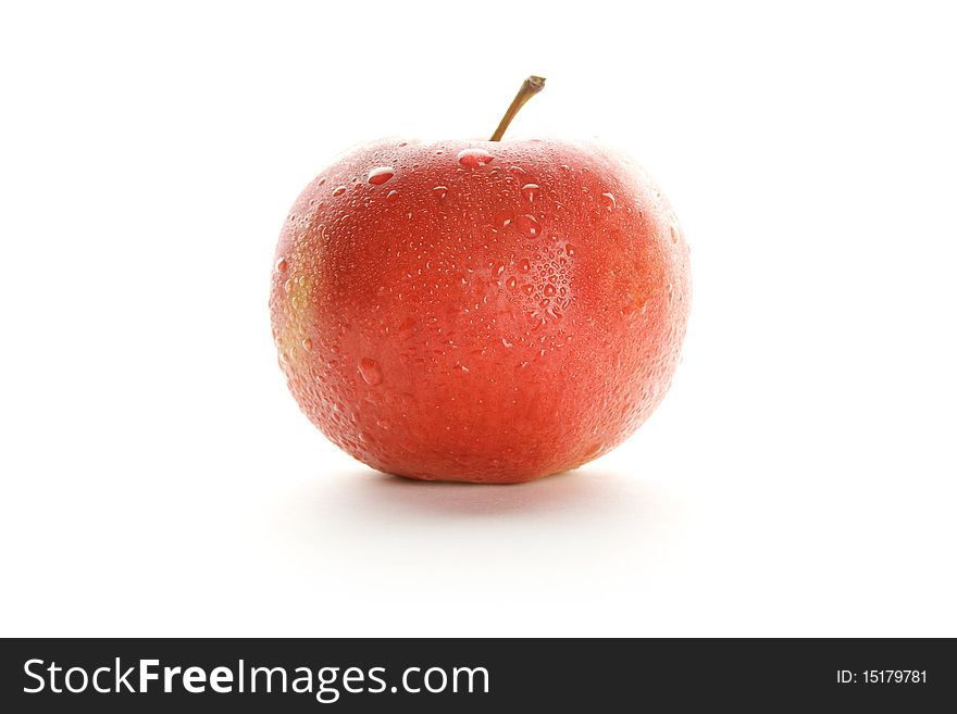 Apple, shot on a white background. It has water droplets and is a frontal view. Apple, shot on a white background. It has water droplets and is a frontal view