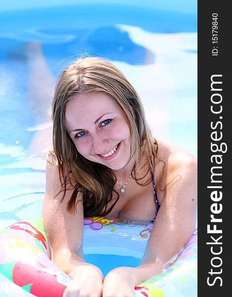Portrait of a beautiful happy woman in swimming pool