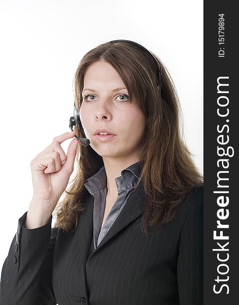 Young woman working at a helpdesk wearing headset. Young woman working at a helpdesk wearing headset