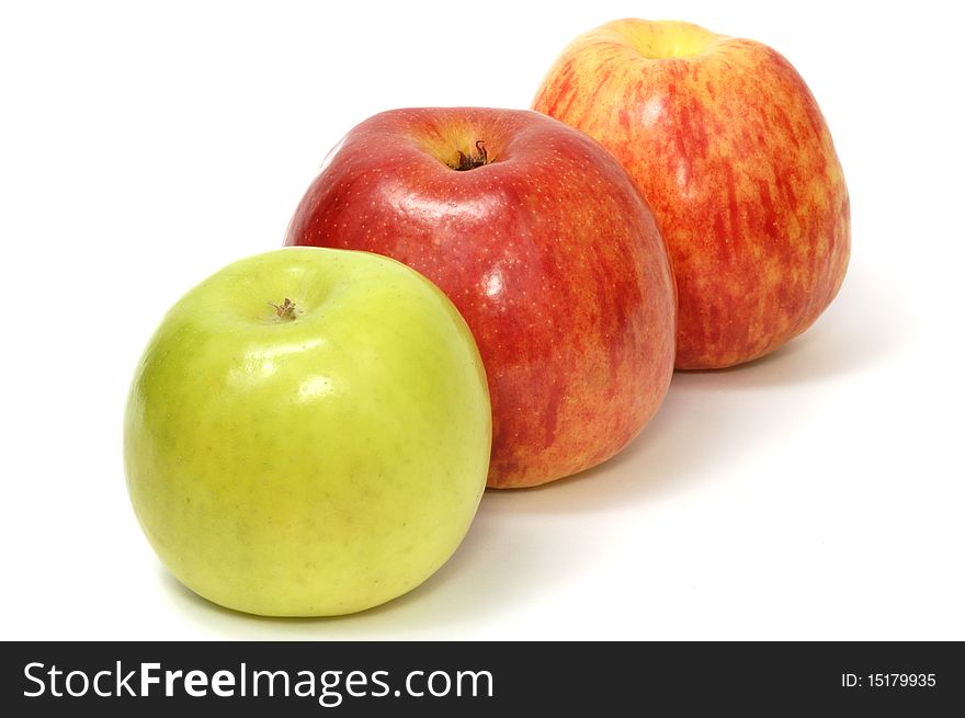 Line of three apples, red and green, on white background