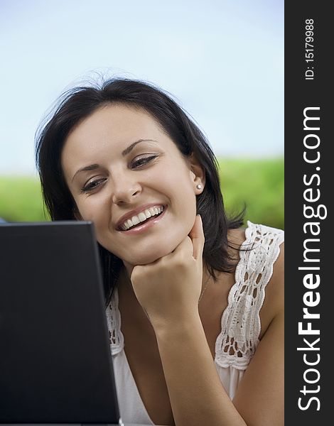 Portrait of woman with laptopm in summer environment. Portrait of woman with laptopm in summer environment
