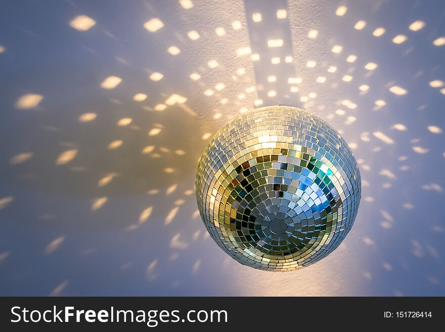 A Mirror Disco Ball On The Ceiling That Sparkles Around Beautiful Glare